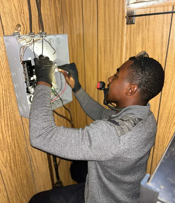Electrician troubleshooting a residential electrical system