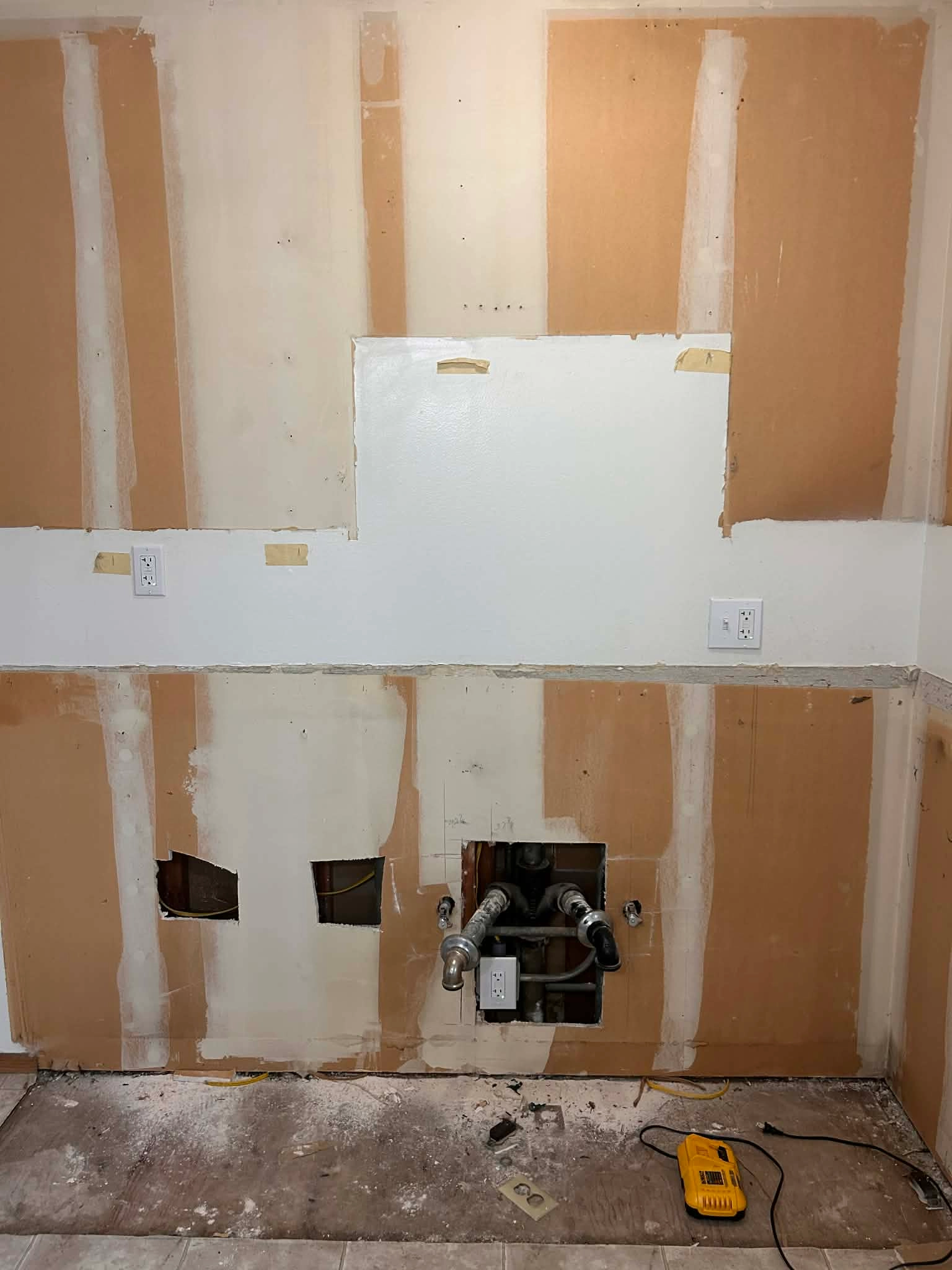 Residential wall opened to access electrical wiring during repair